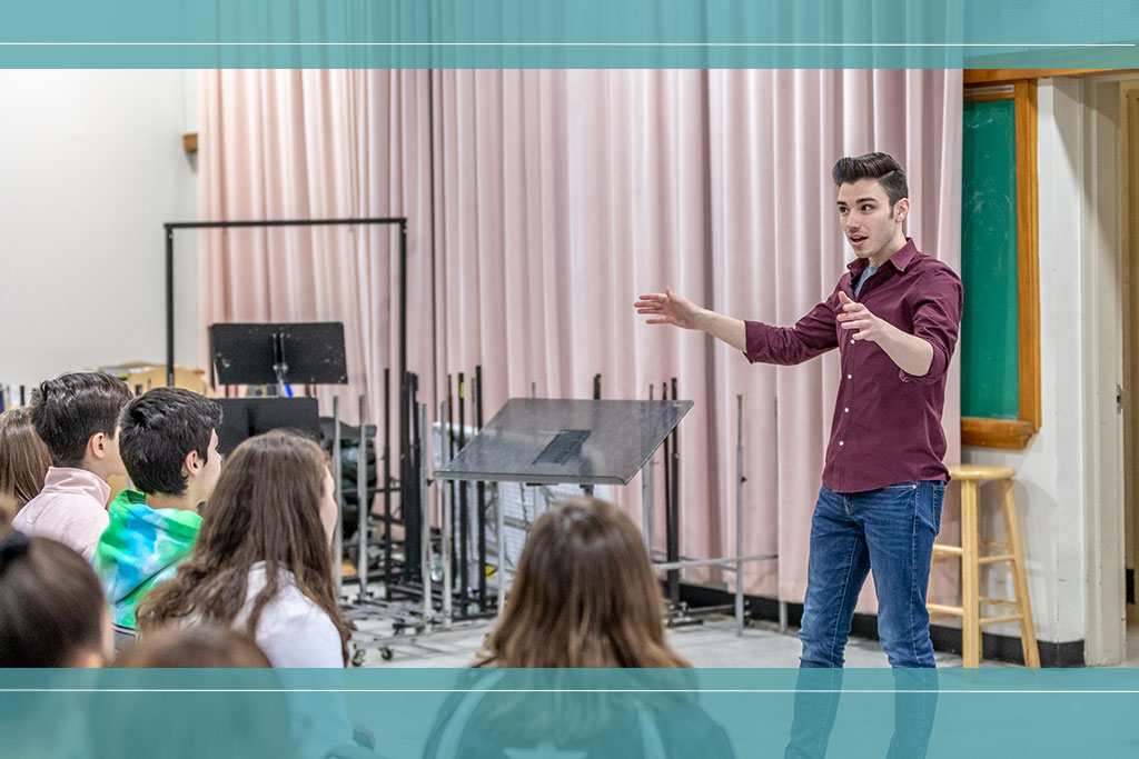 Music ed student leads class of young local students.